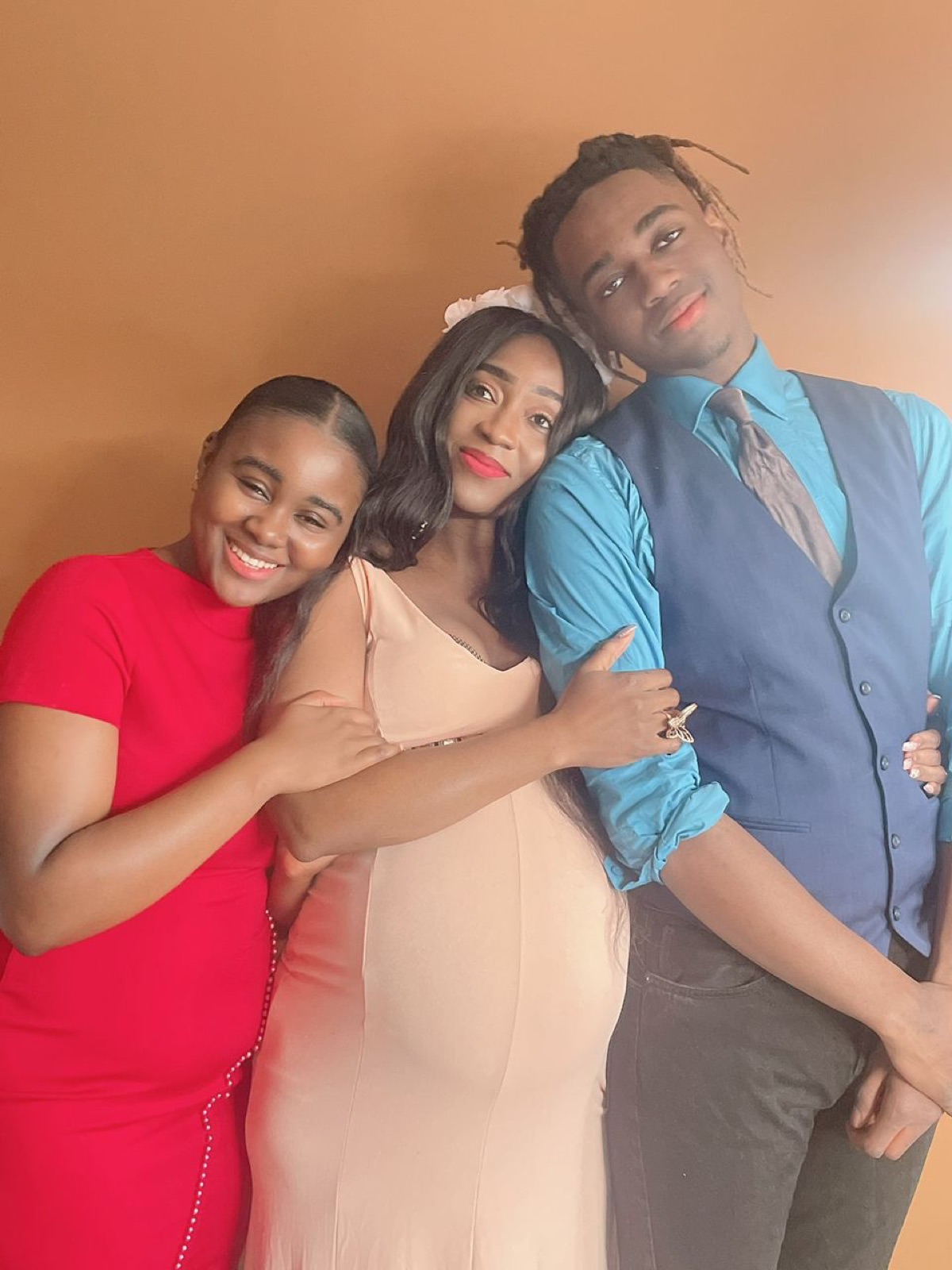 Zeinab, pregnant with her twins, embraced by her two eldest children